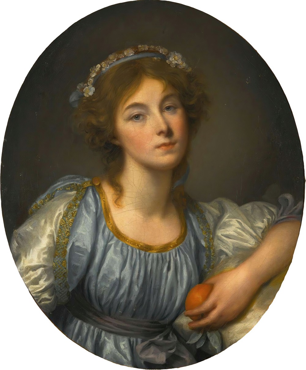 A Young Girl Holding An Orange