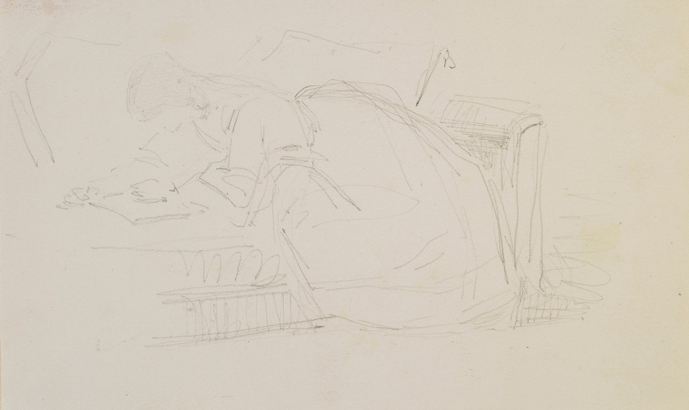 A girl reclining on a couch, reading