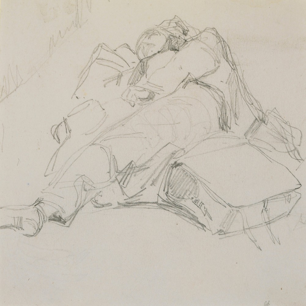 A man asleep on a pile of luggage