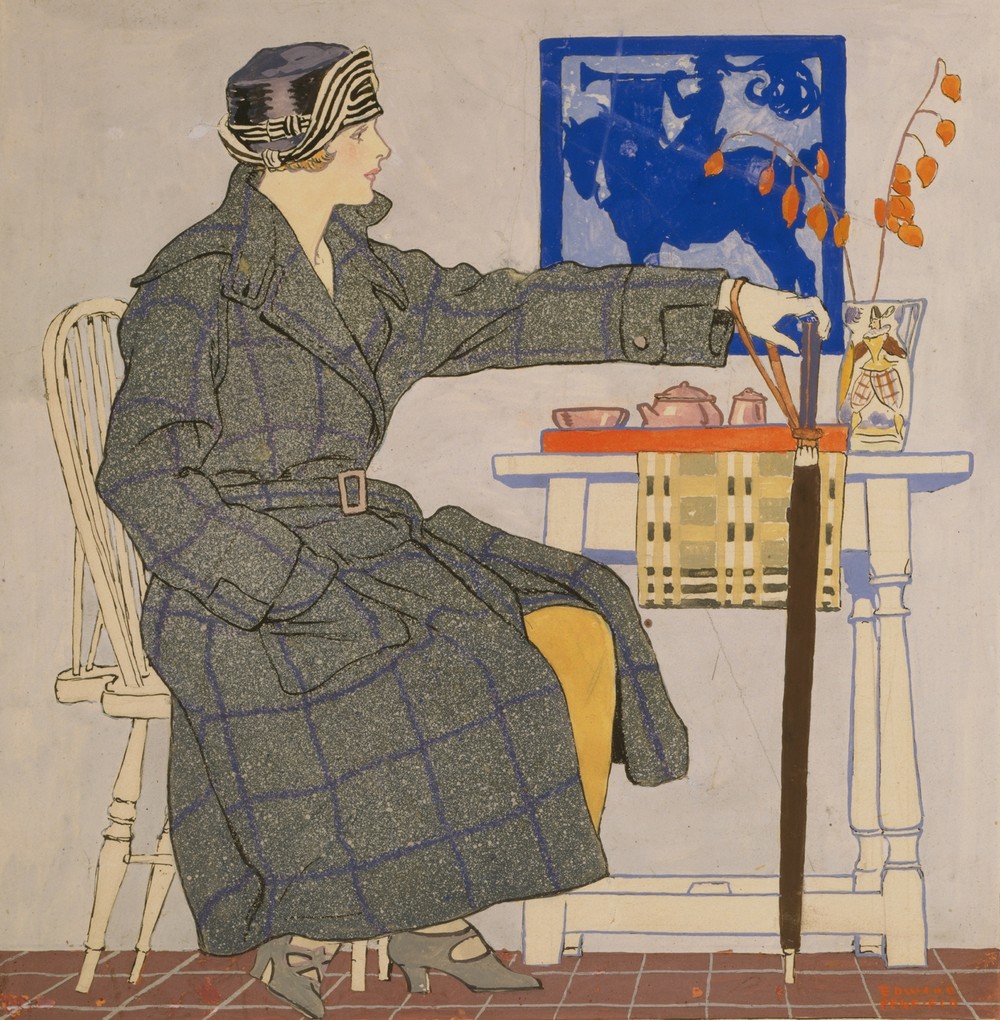 Young woman sitting beside table holding umbrella