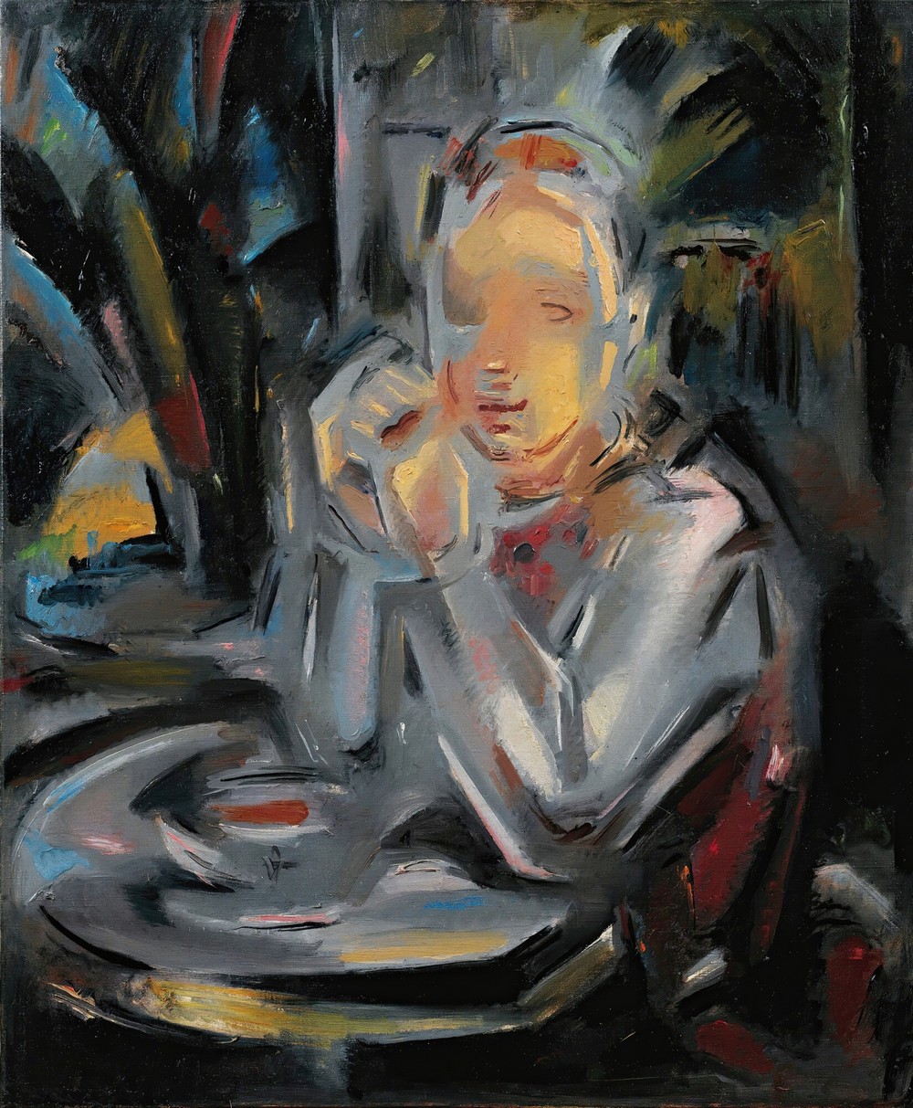 Jeune Assis À Table Face À Une Tasse