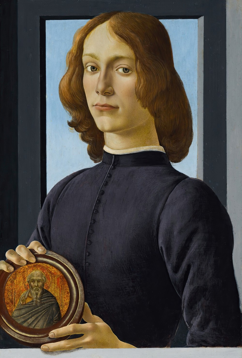 Portrait of a young man holding a roundel